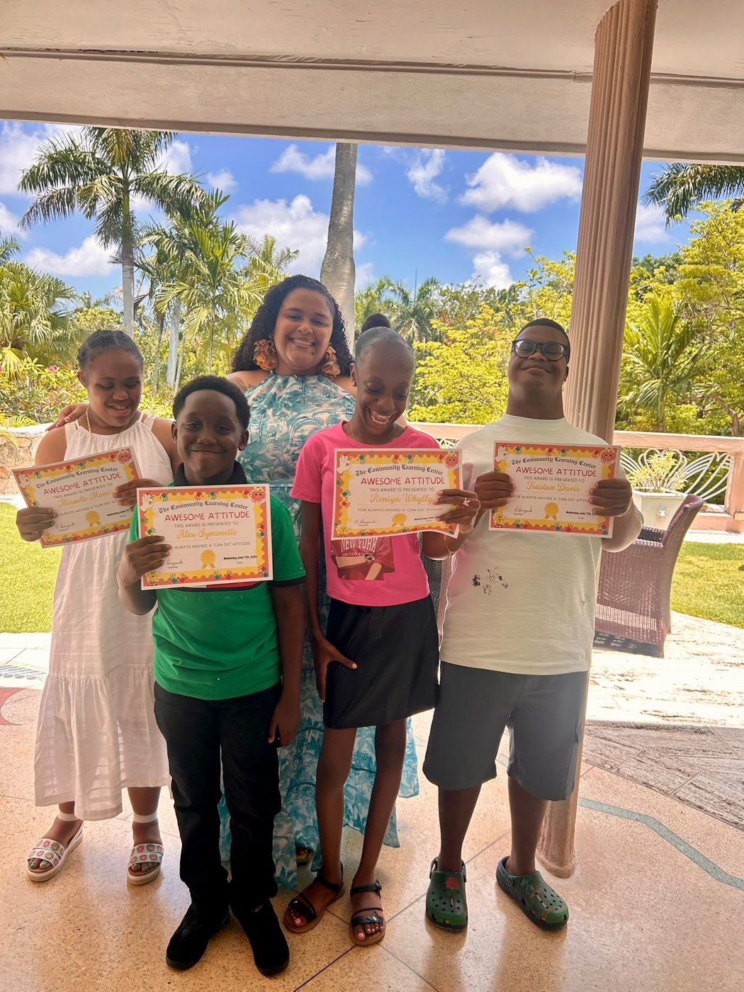 Students proudly showing their achievement certificates
