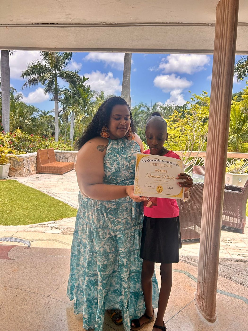 A student and teacher celebrating success